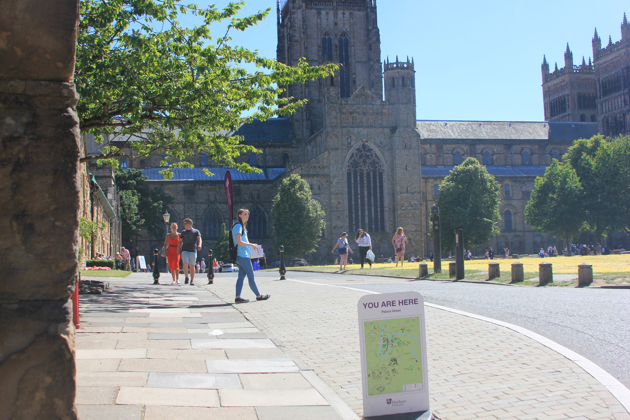 Potential students exploring Palace Green in front of Durham Cathedral