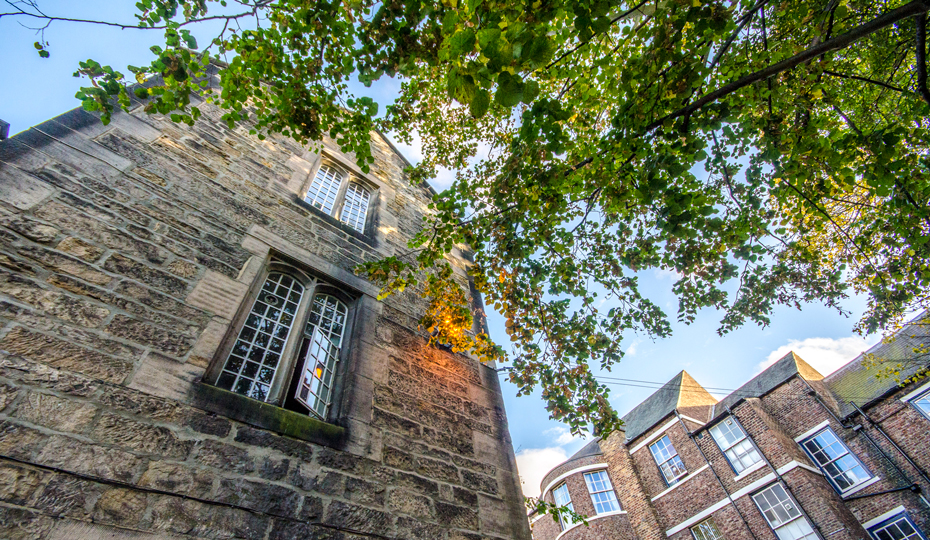 Looking up at an open window on a college building