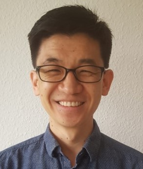 A profile picture of Dr. John Bai smiling