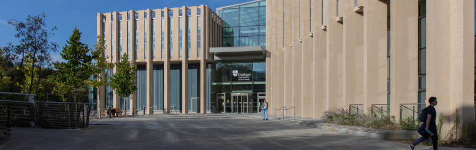 Entrance of Waterside building on a sunny day with a couple of people walking outside
