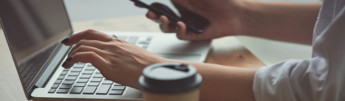 Laptop phone coffee and hands