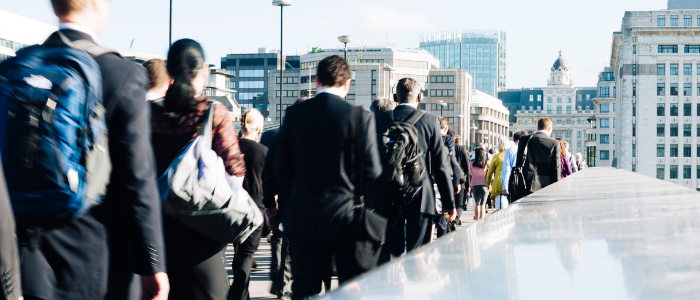 Business people commuting over London Bridge