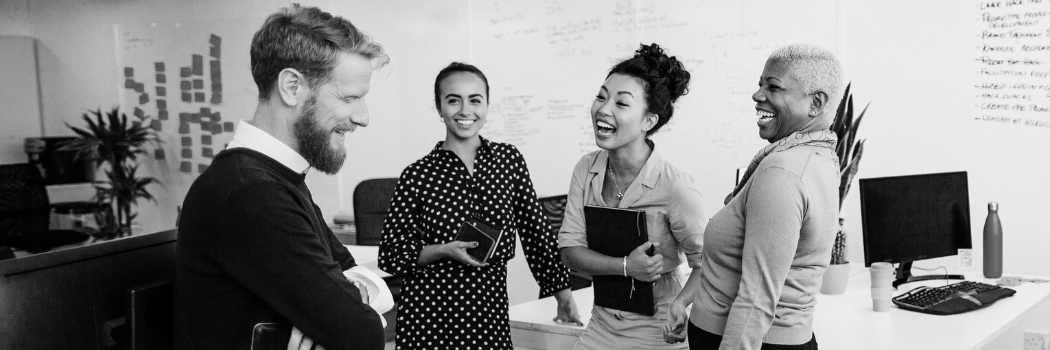 Work colleagues smiling in office black and white