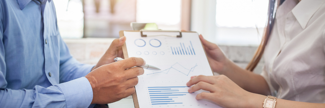 Image of business people examining data charts