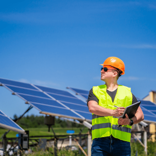 Green energy worker conducting an on site inspection with solar panels
