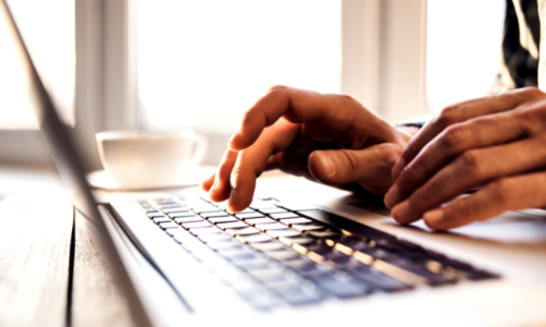 Person working on a laptop keyboard