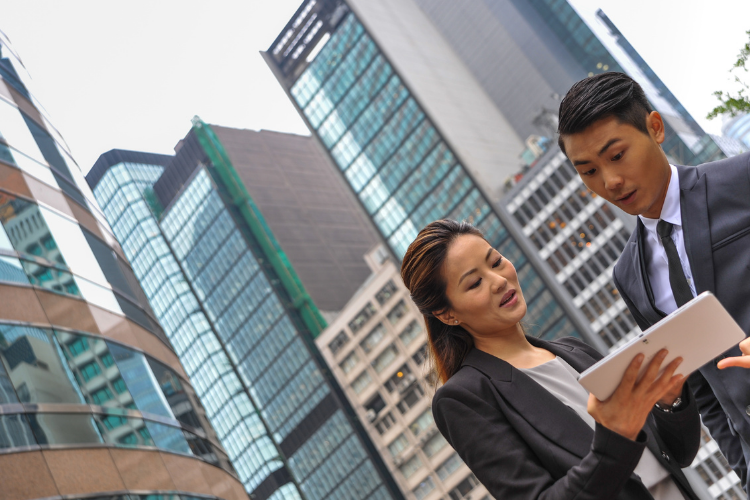 Two Asian business people and city scape