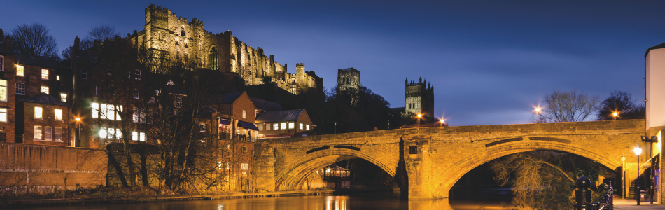 Framwellgate bridge, Durham Castle, and Durham Cathedral lit up at night