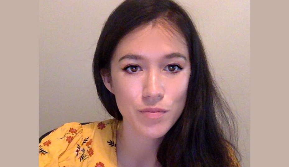 Headshot of female with dark hair and yellow top