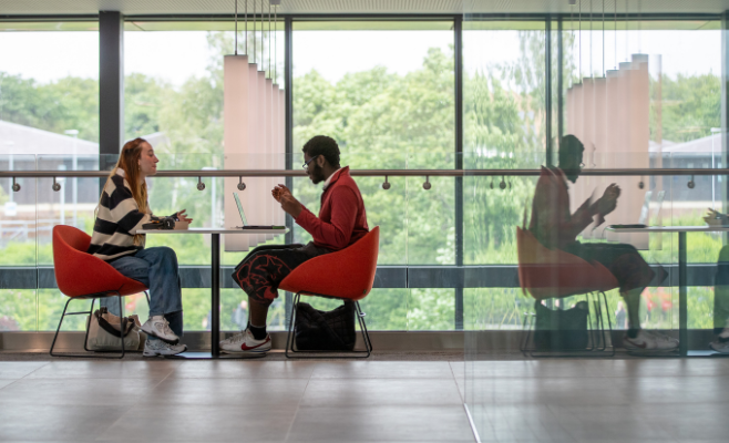 Two students work at a table in Maths and Computer Science