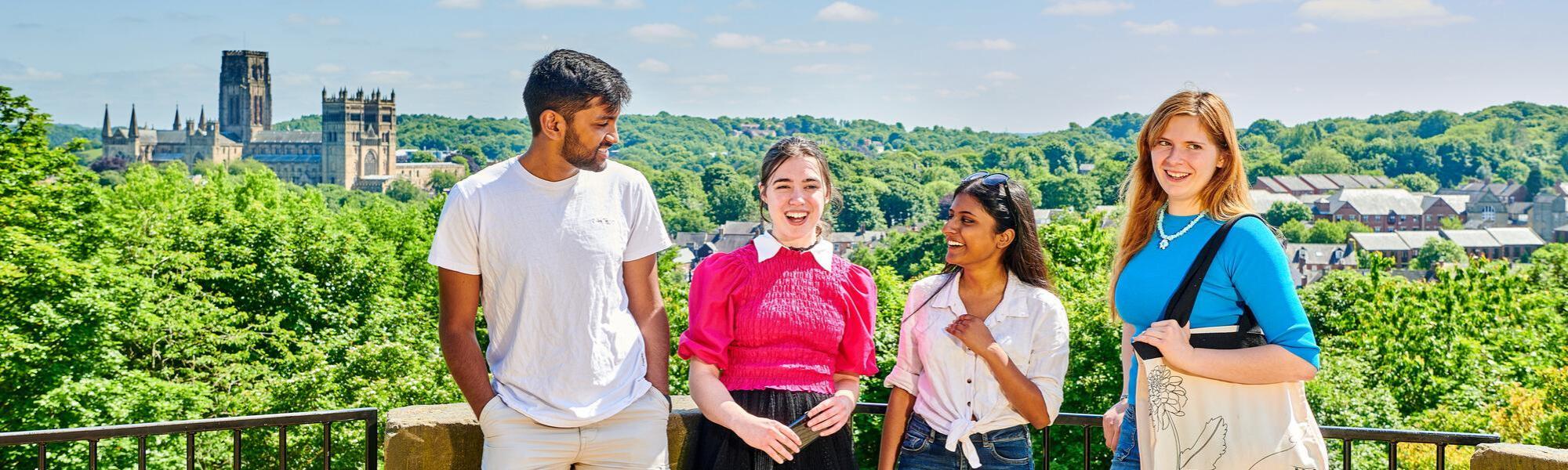 Students on a sunny day with Durham Cathedral in the distance