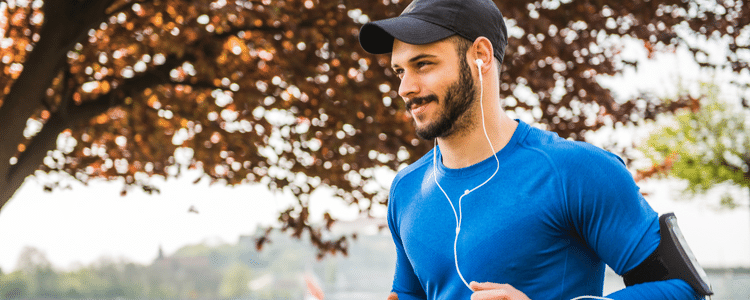 A man running outside with headphones.
