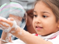 A girl playing with a bubble