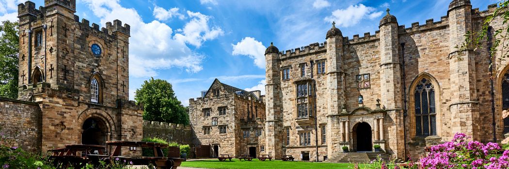 Durham Castle courtyard with a blue sky and white clouds background