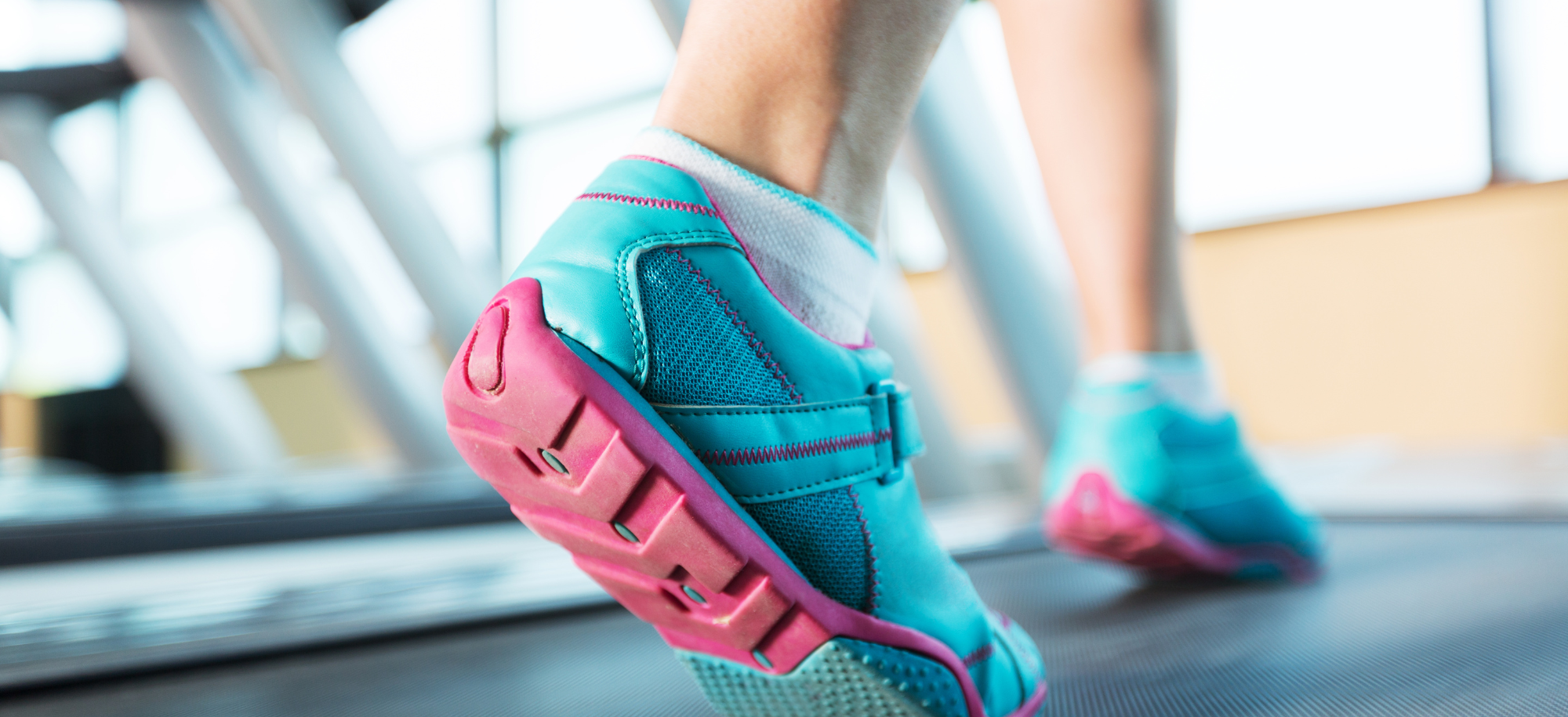 Image of feet in trainers walking on a tredmill