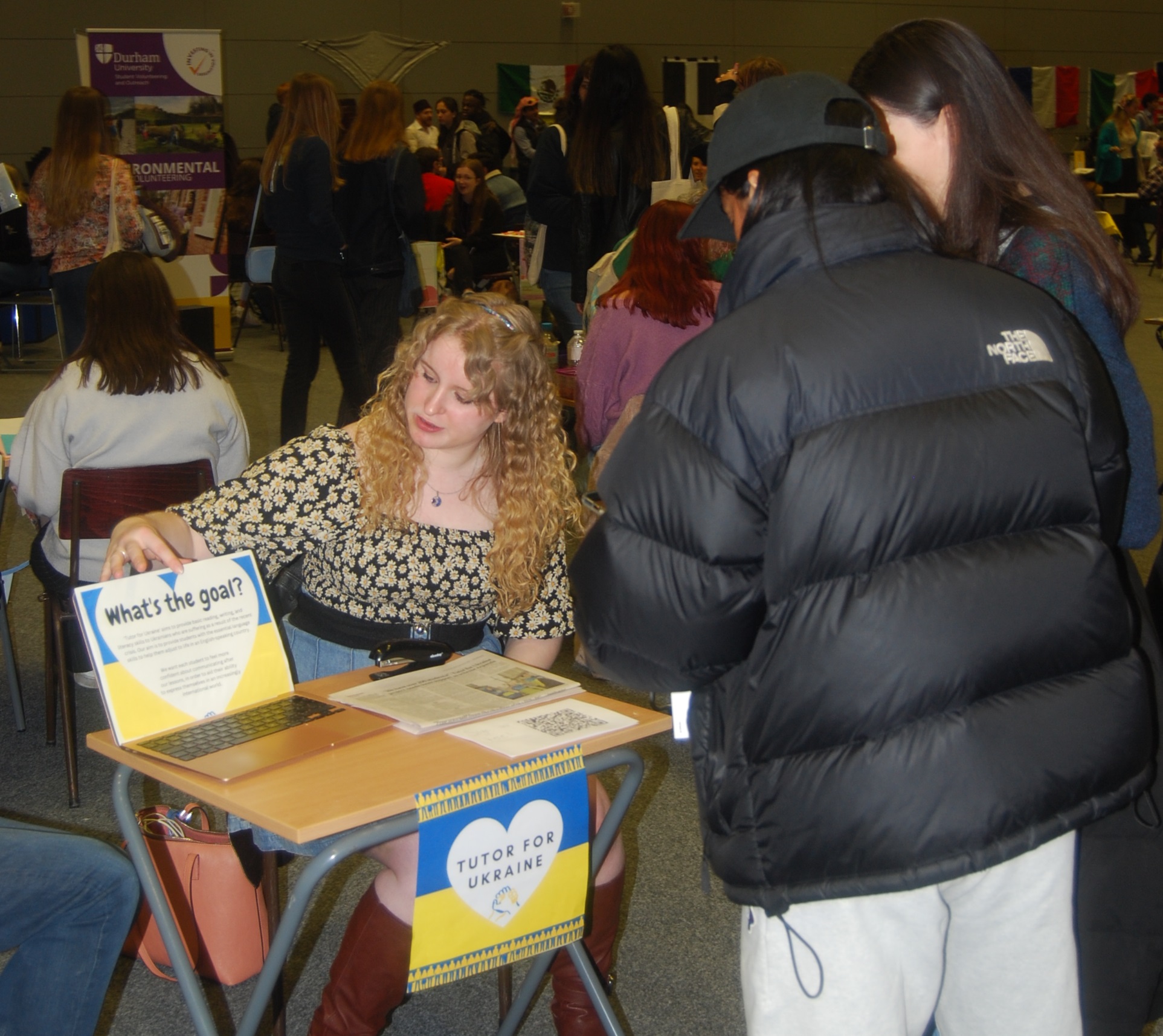 The Tutor for Ukraine project leader talking to two students at the Freshers' Fair