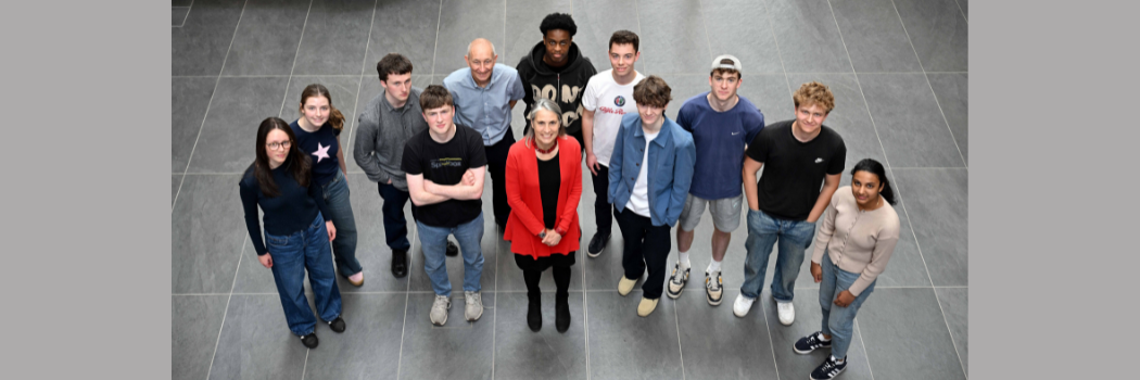 A group of students dressed casually stood with Chancellor Dr Fiona Hill