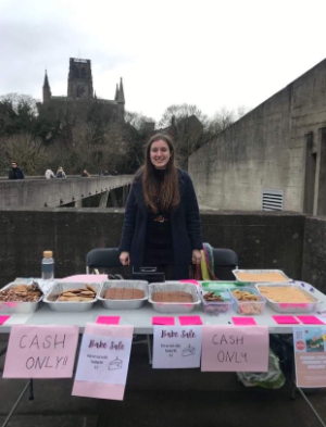 Student volunteering at a bake sale