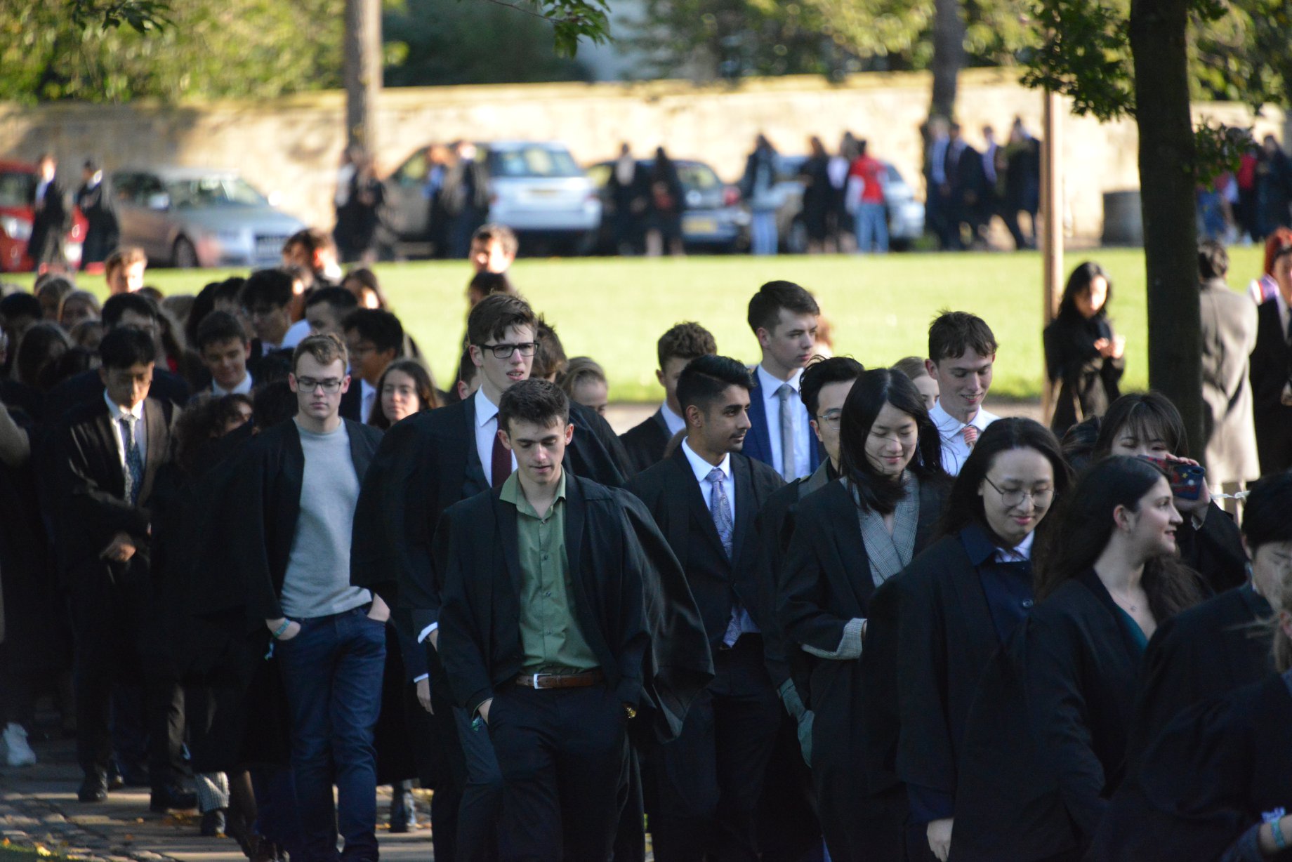 A group of students in gowns leaving the Cathedral having matriculated