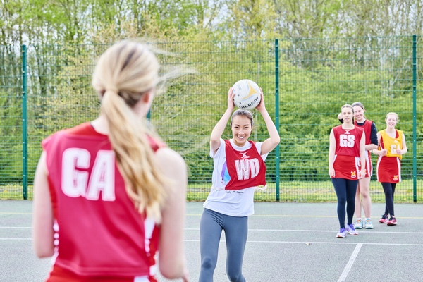 Three girls playing netball