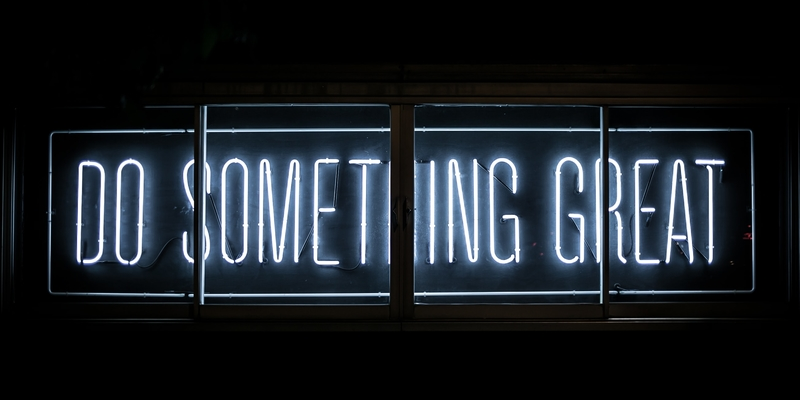 Picture of a neon sign that says Do Something Great