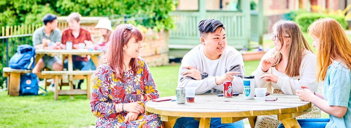 students chatting outside on campus