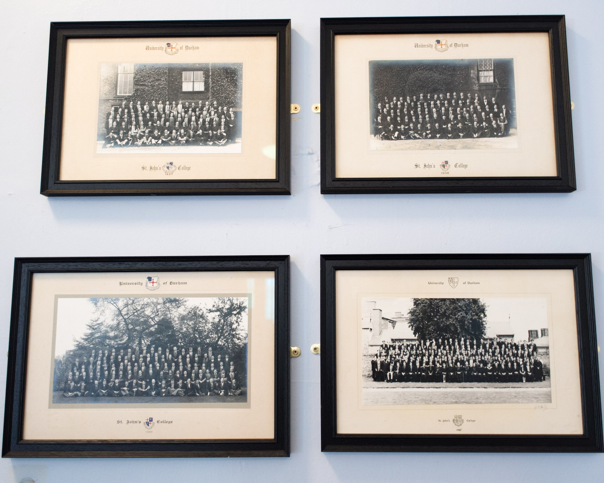 Framed black and white photographs of past students