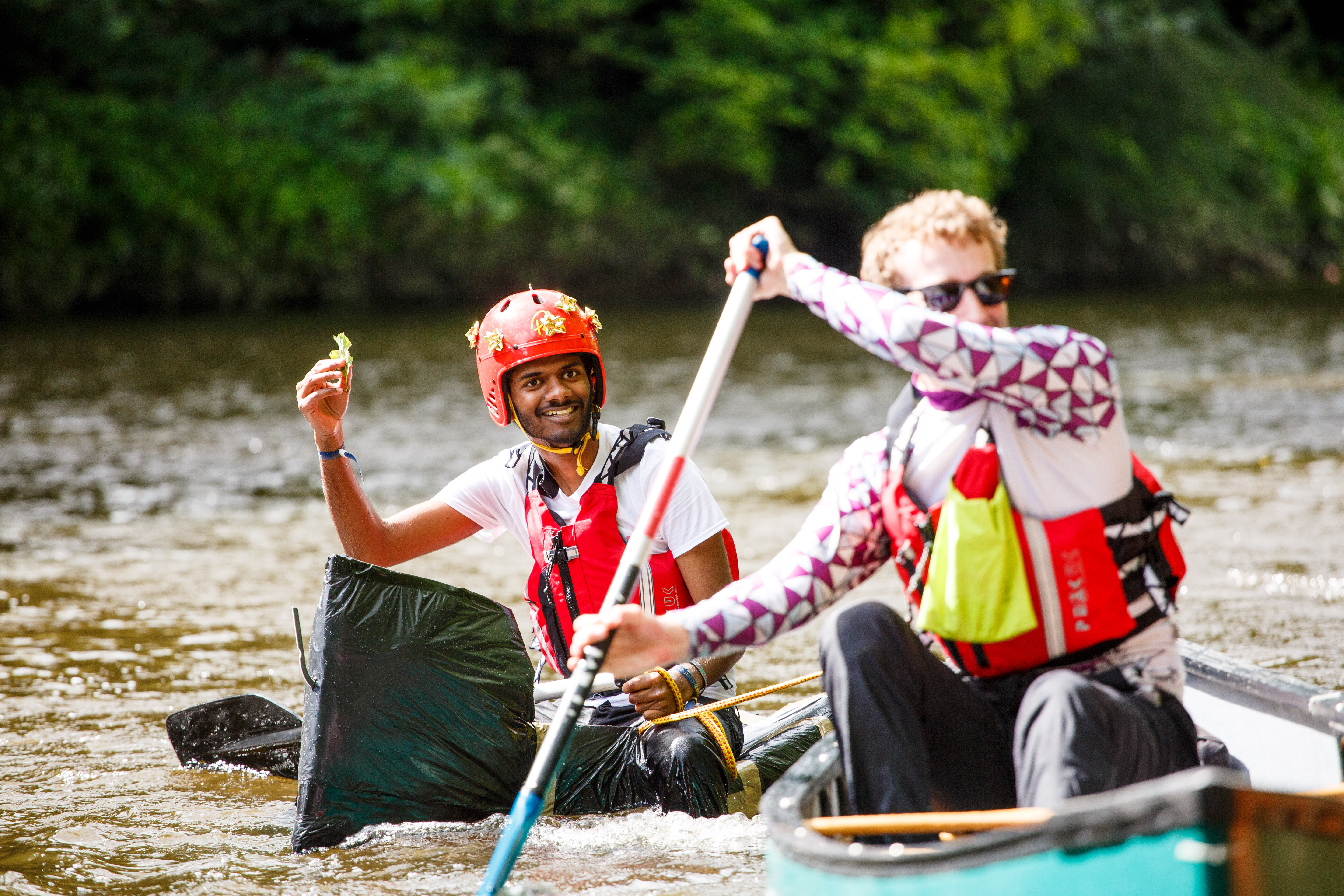 Two students canoeing on the river