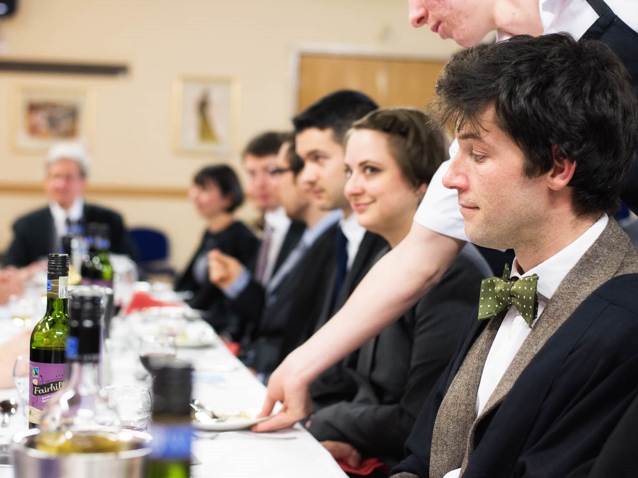 TStaff sitting round a table enjoying wine and an evening meal