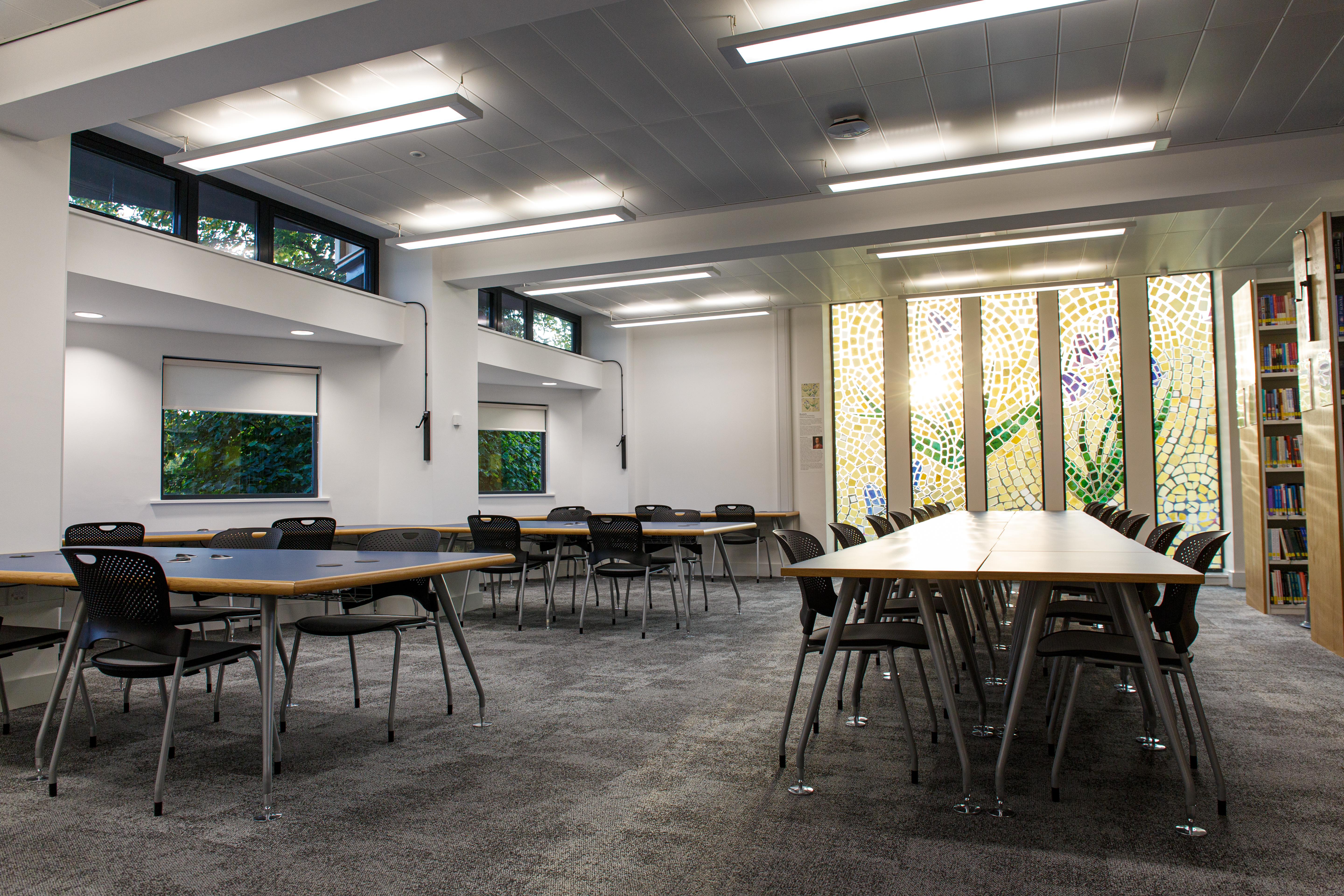 Study space for students with bookshelves, tables and chairs
