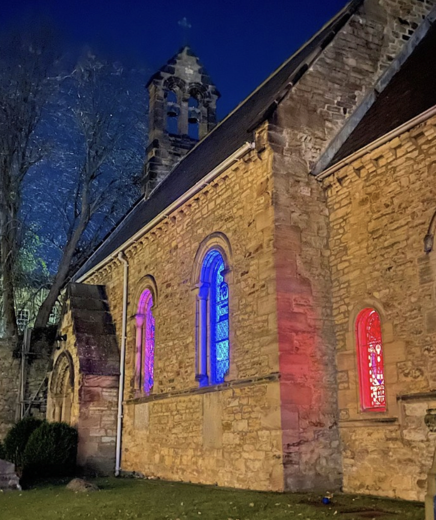 chapel with coloured lights in windows