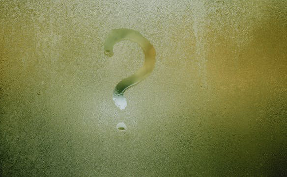 Question mark drawn in condensation on a window