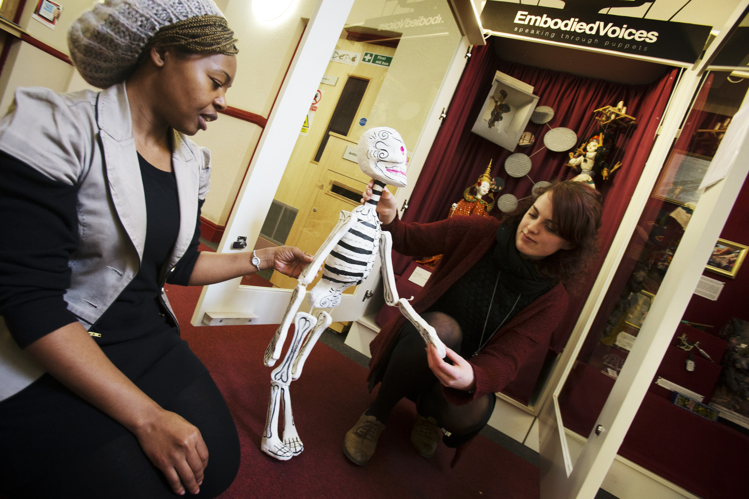 Students holding a skeleton puppet