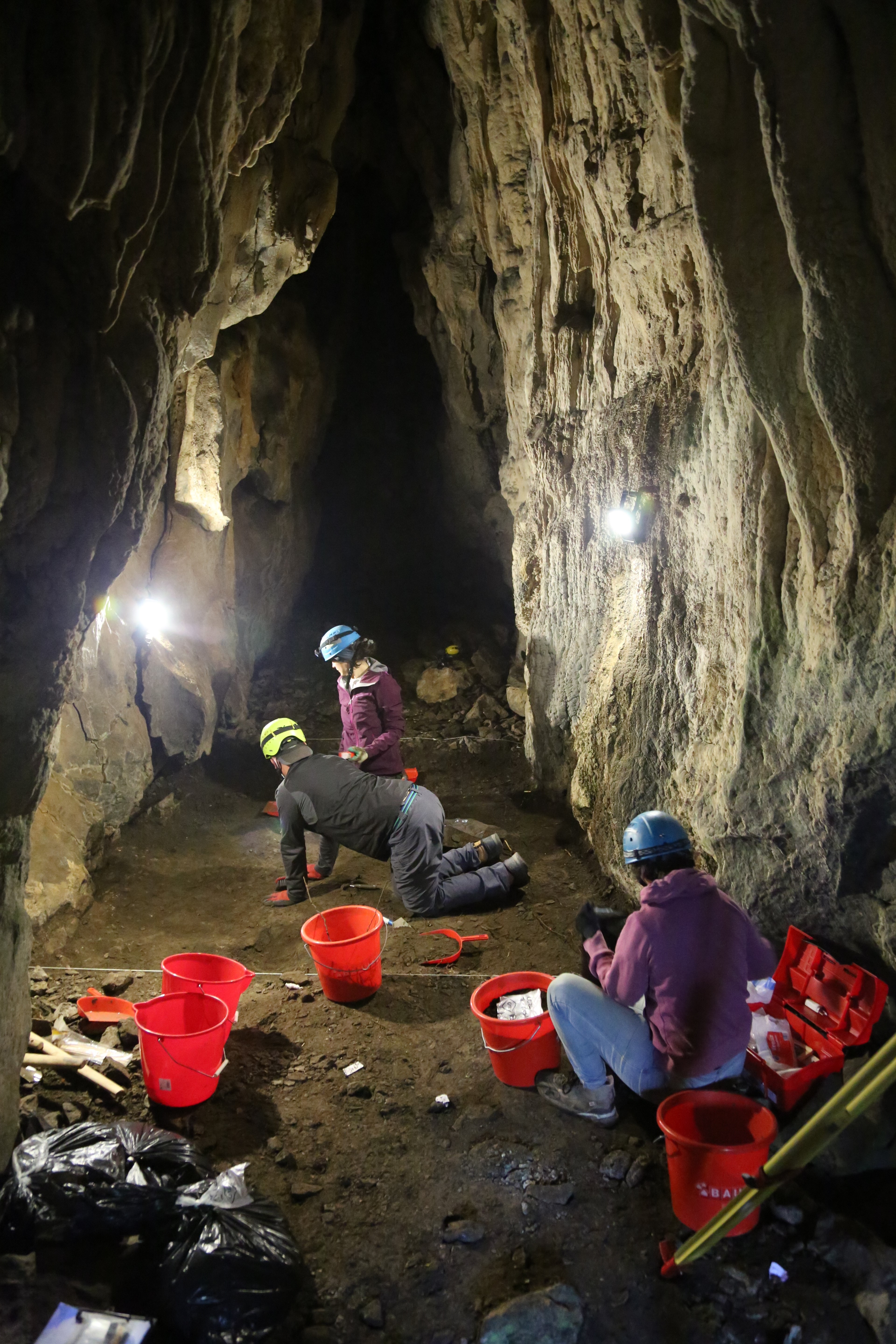 Archaeologists working in a cave