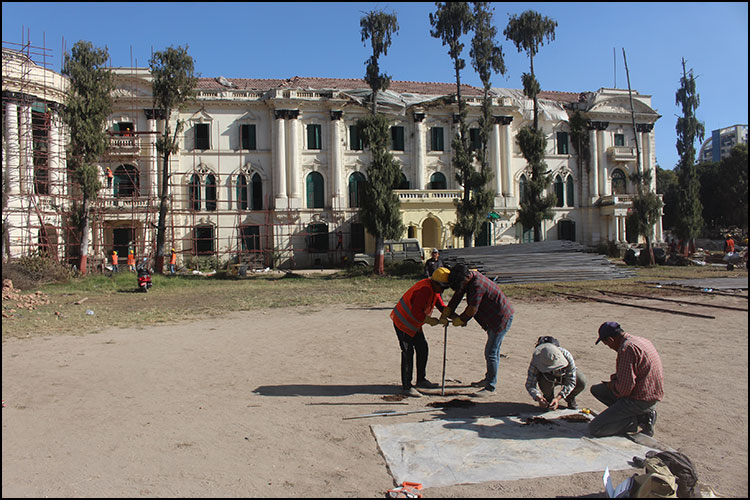 Photograph of archaeologists undertaking a core survey with an auger