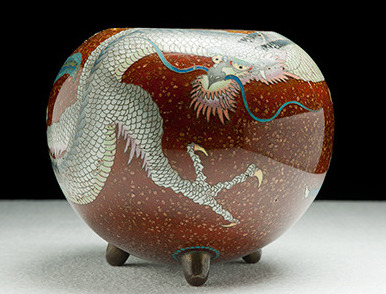 A porcelain object decorated with an image of a dragon