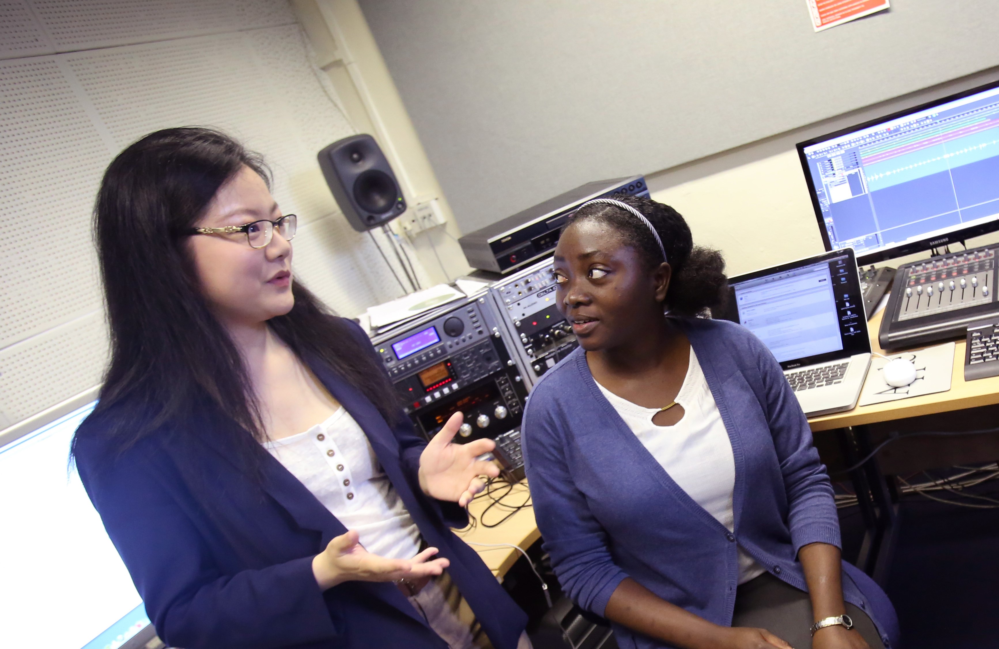 Two women talking to each other in the Music department