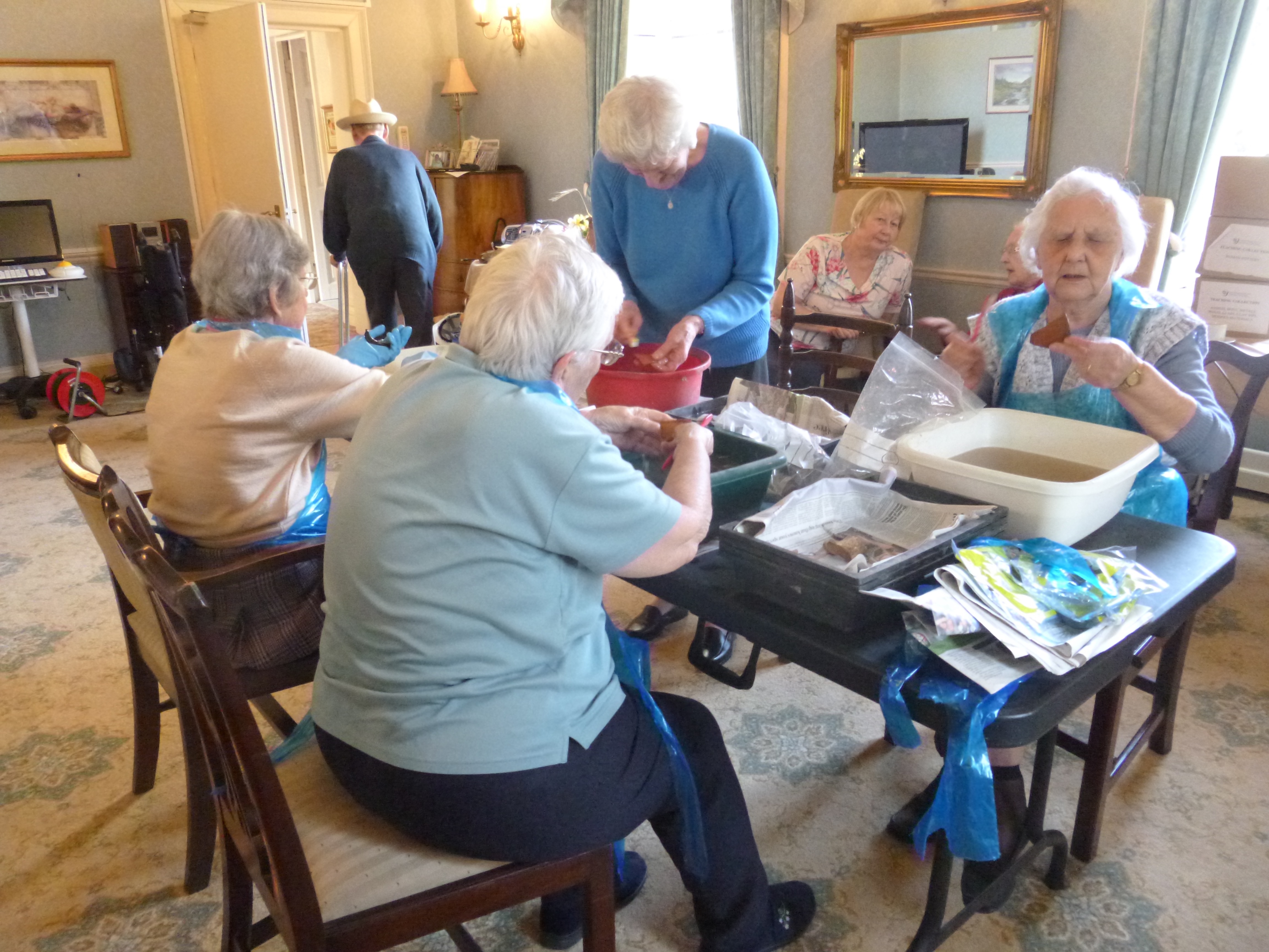 Care home residents washing human bone