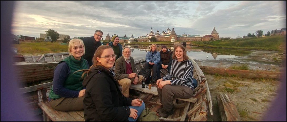 A group of staff and students on a boat