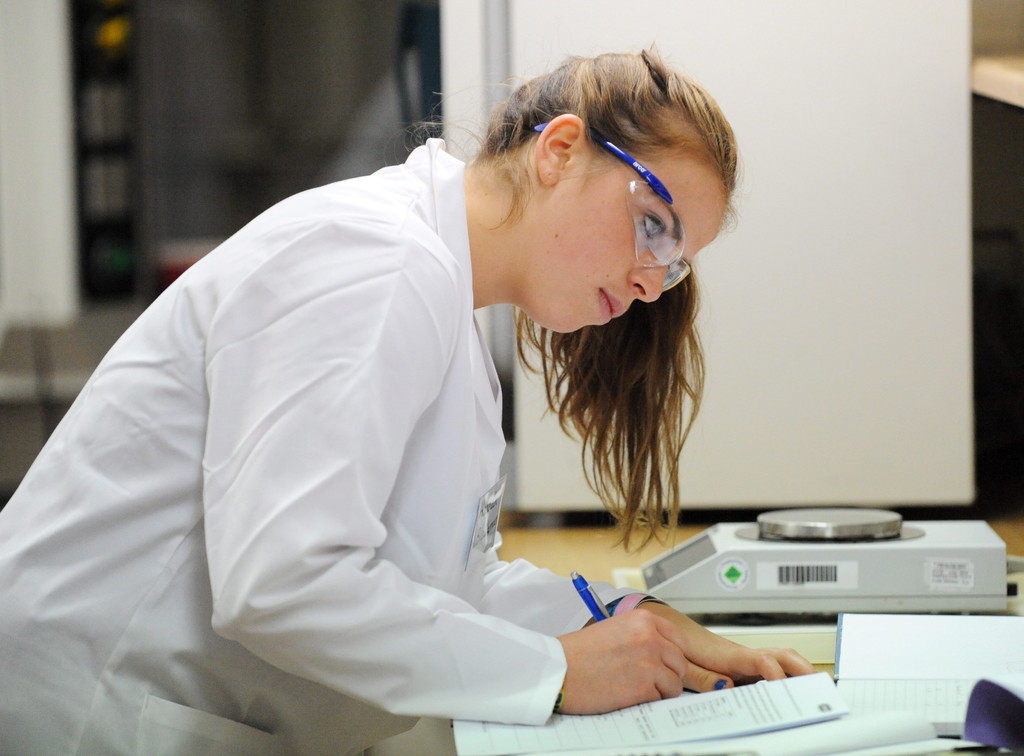 TA student writing at a desk in a Chemistry laboratory session