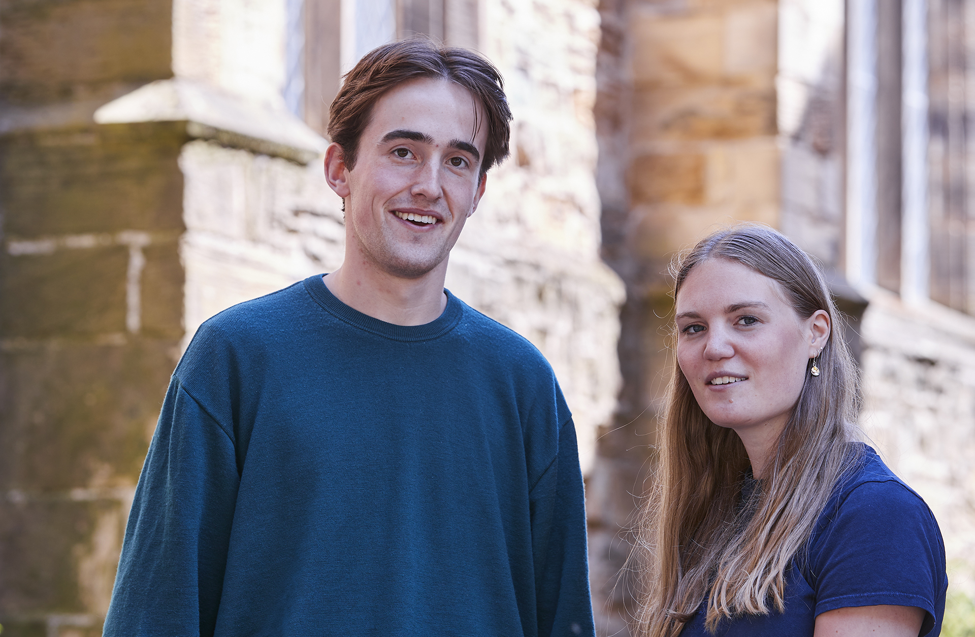 Male and female Classics students looking at towards the camera.