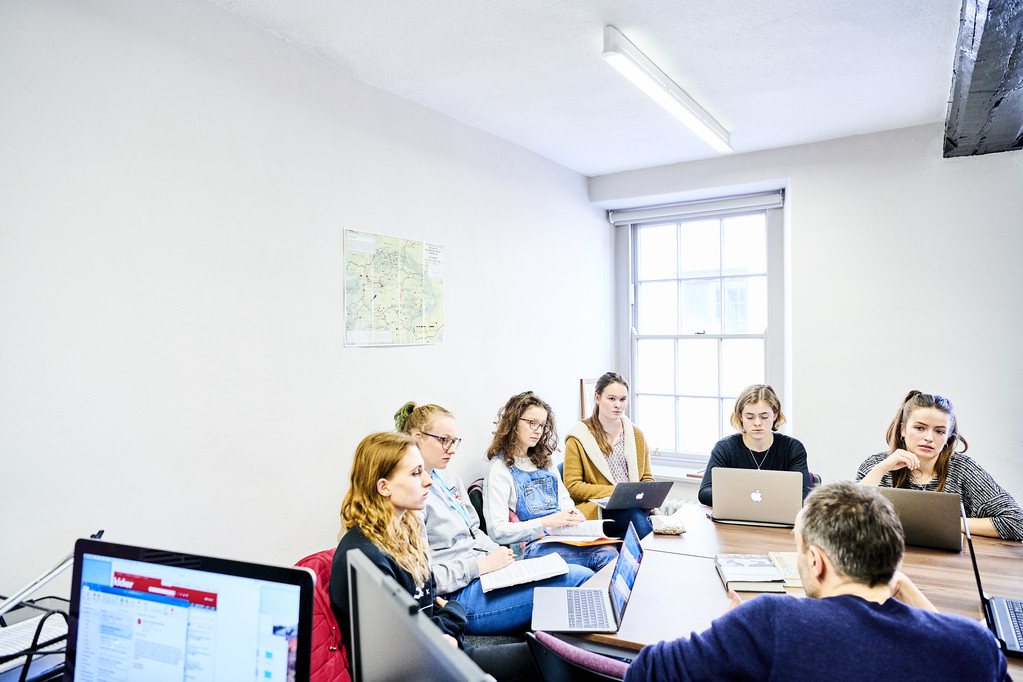 A large group of students in discussion in a seminar session