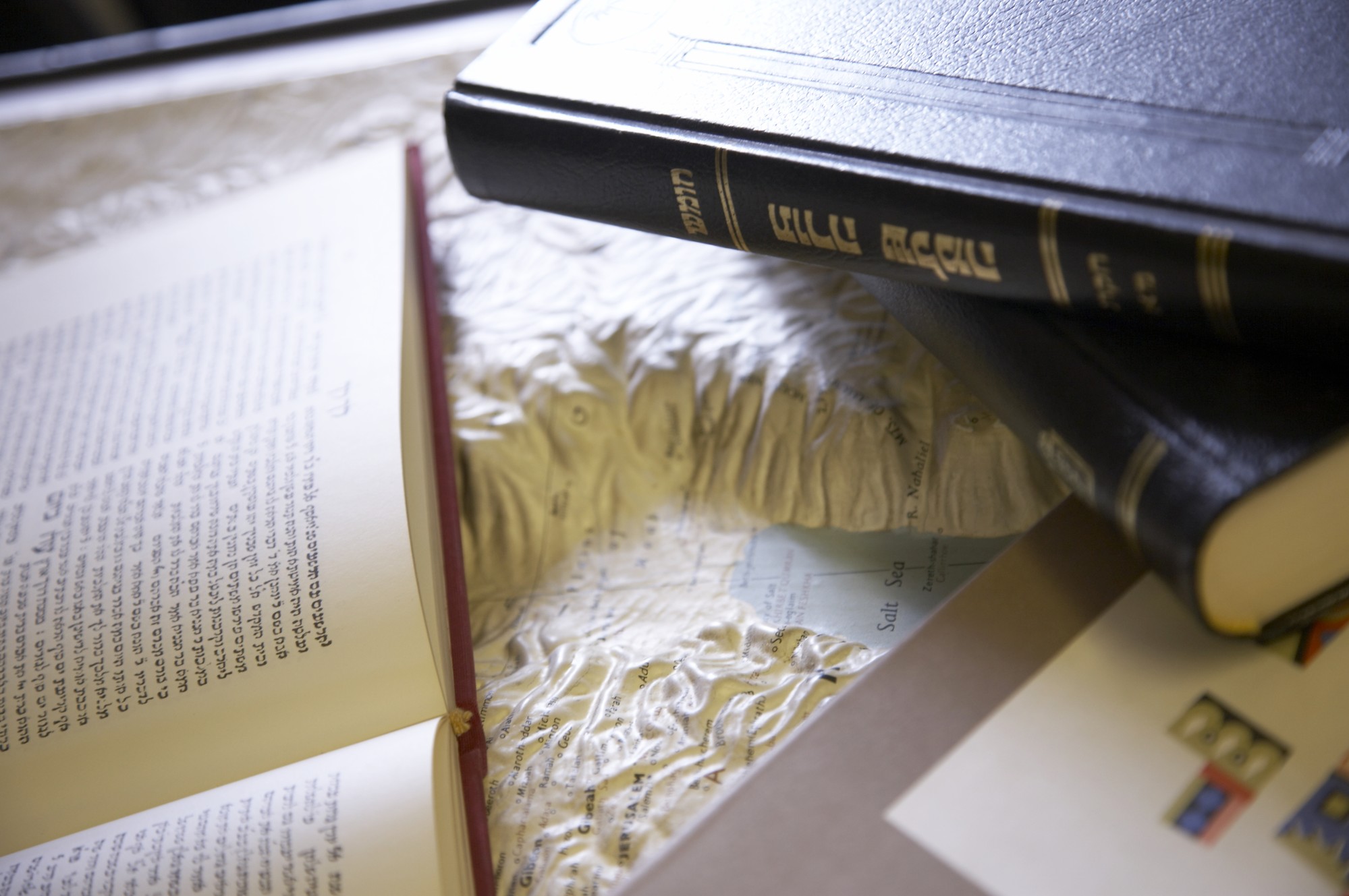 Close-up of books resting on 3D map