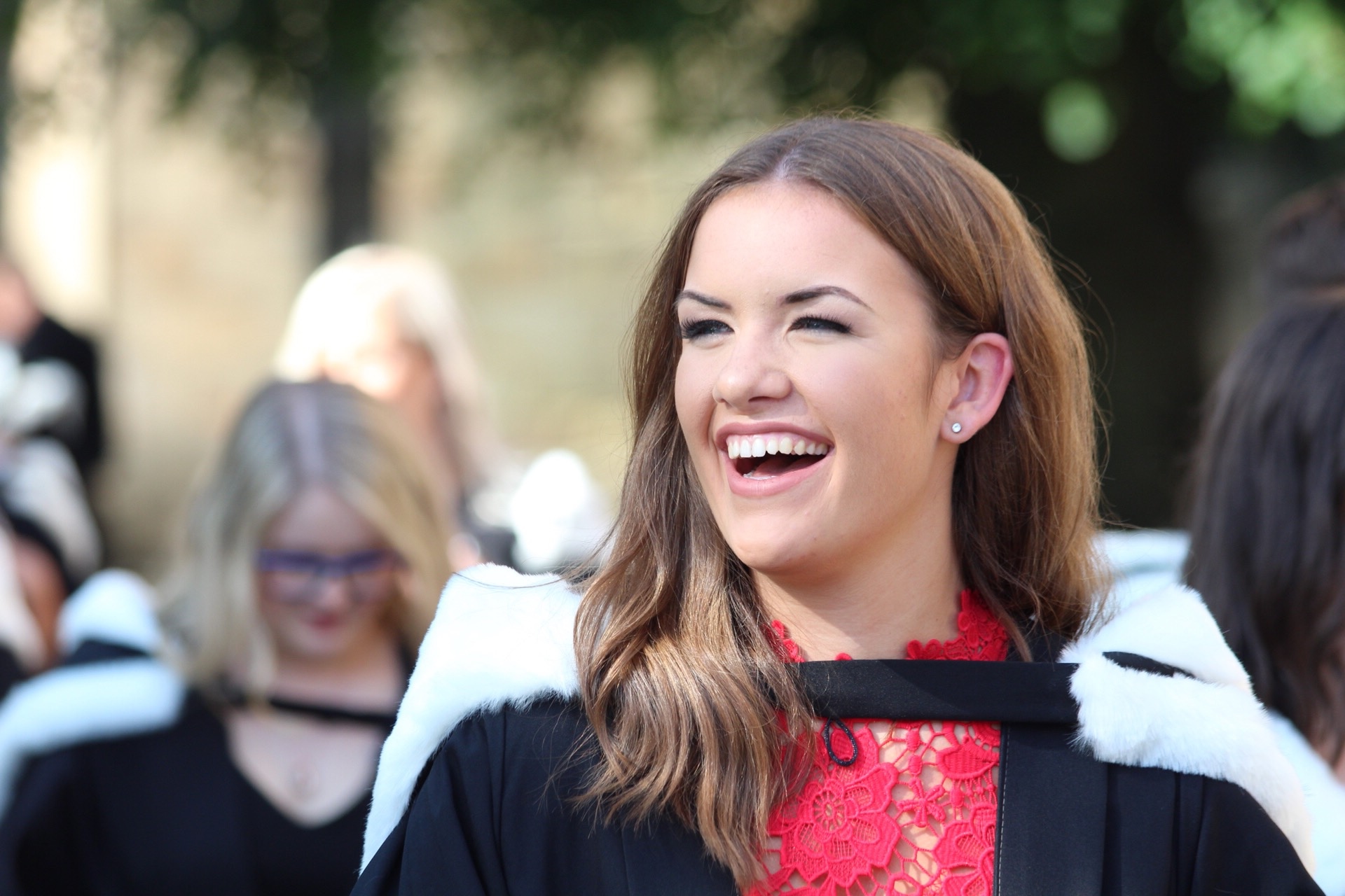 Female graduate smiling at graduation ceremony