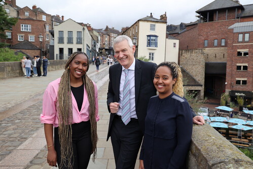 Jeremy Vine stands with two young women in Durham City Centre.