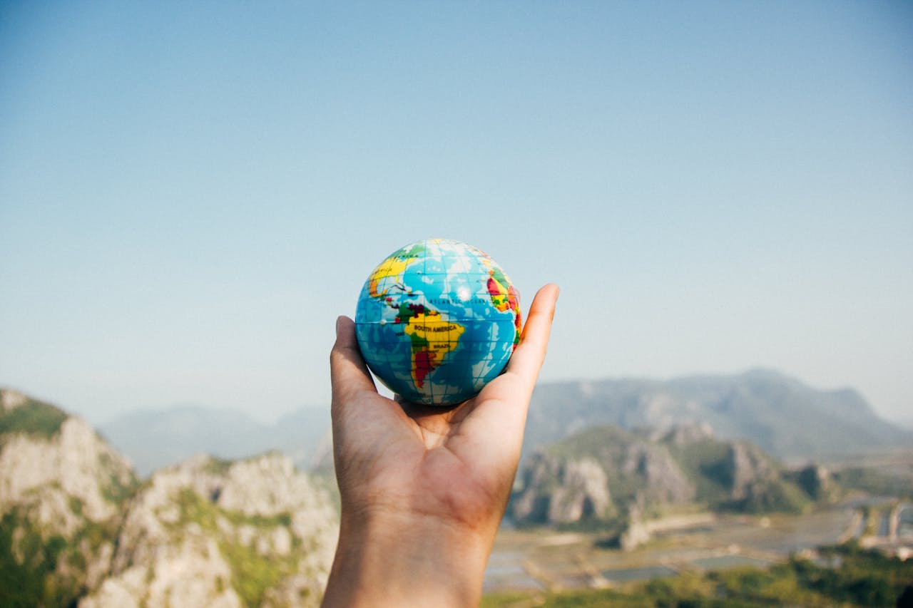 Hand holding a tiny globe