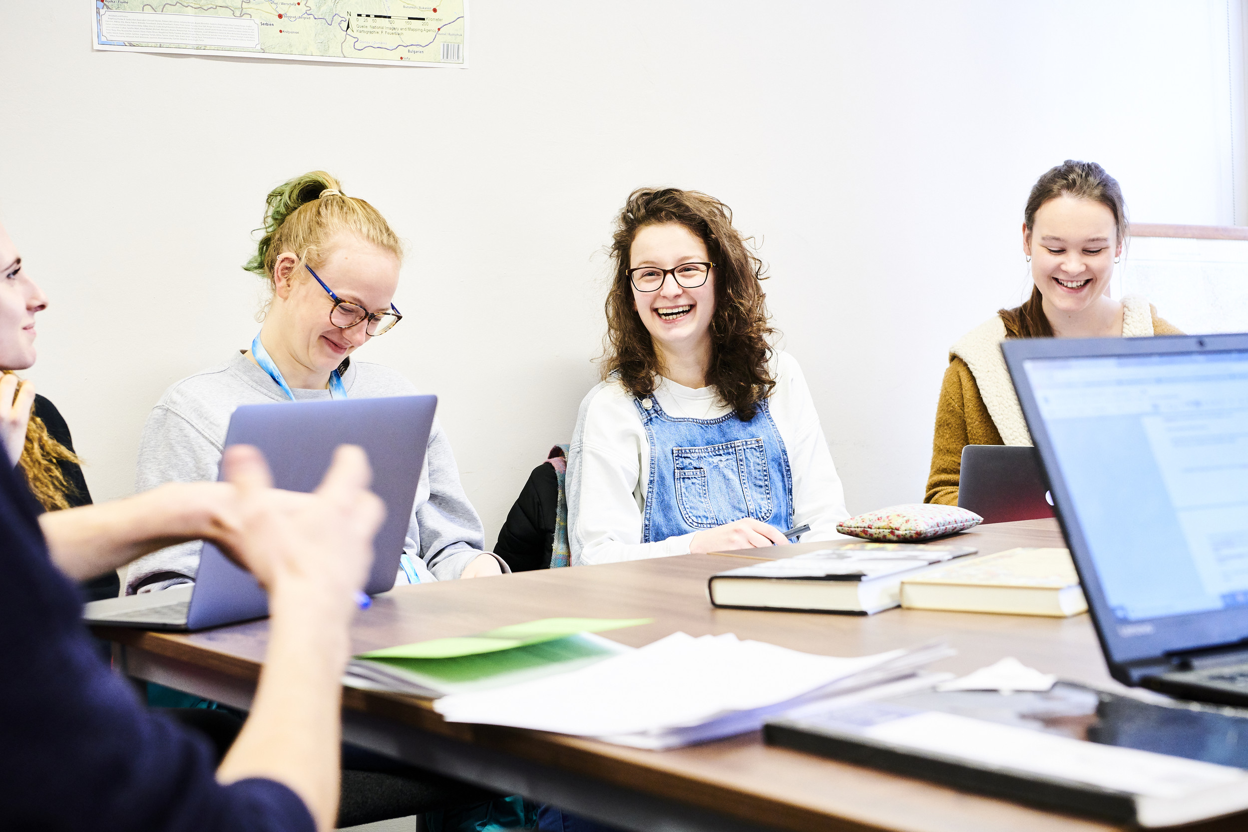 Students sat round a table engaging in a seminar