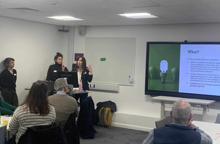 Staff presenting to a group of people in a seminar room