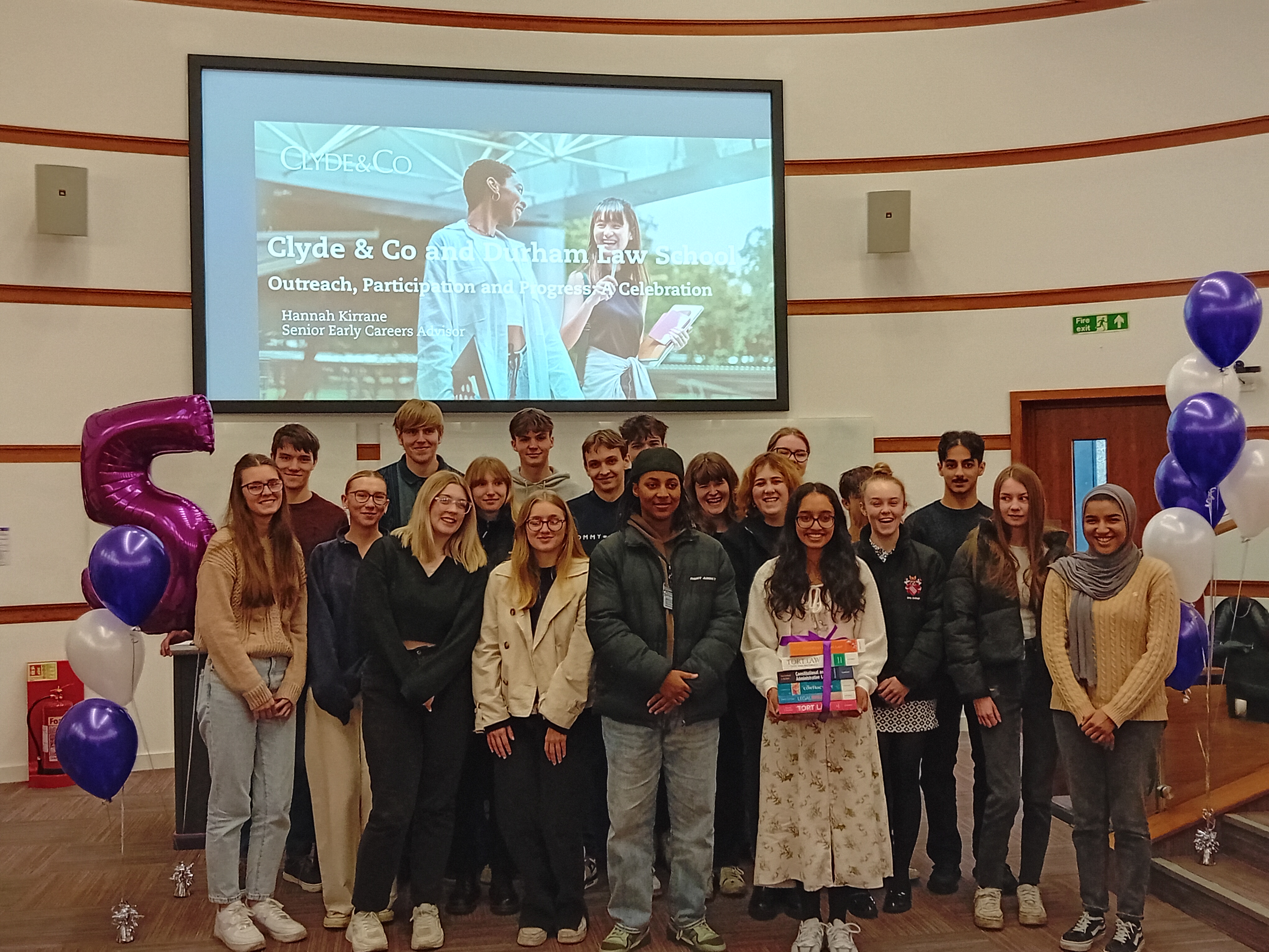 Students standing in front of a ppt that says Clyde&Co and Durham Law School
