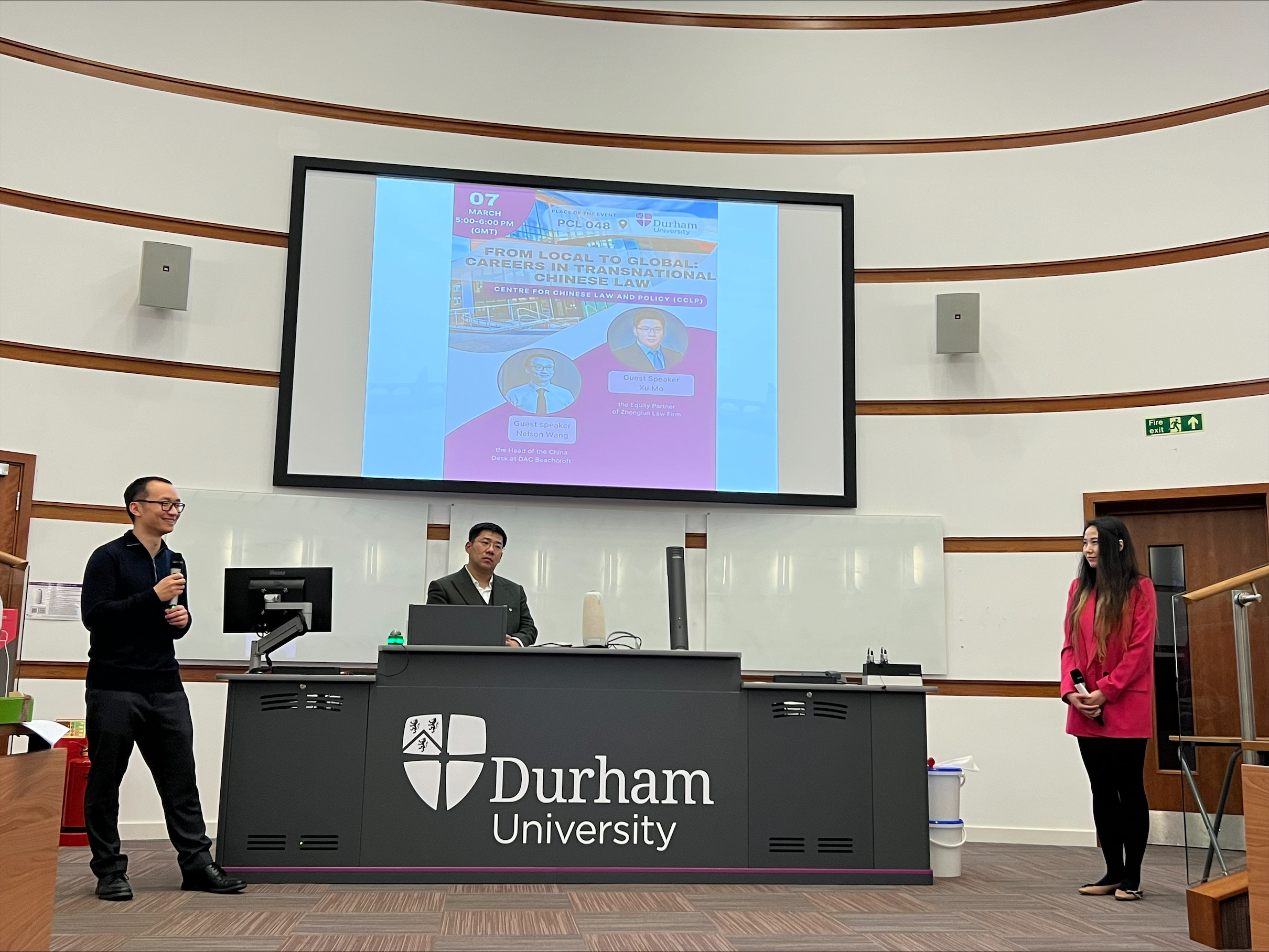 Three people presenting at the